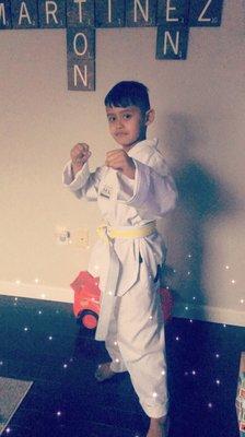 Got his new white with yellow strip belt