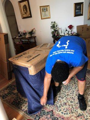 Andre wrapping and protecting our furniture