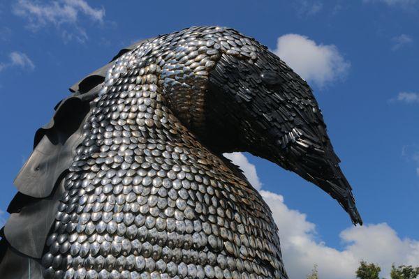 The Daddy Penguin's front is made of spoons welded together and the face/beak are from silverware handles.