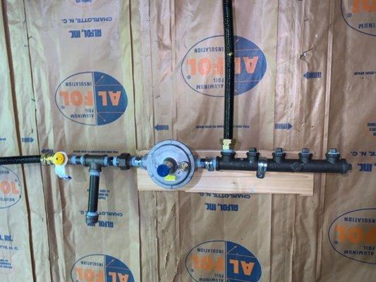 New gas line ran with 4 port manifold for water heater and future appliances!