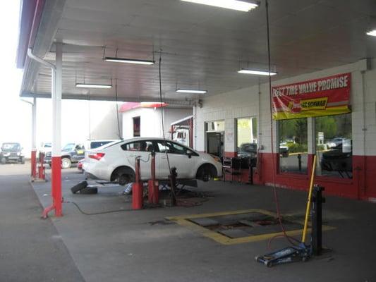 Cars are moving in and out of these bays.  This zone is where they'll install tires, rotate and balance tires, and do flat repairs.