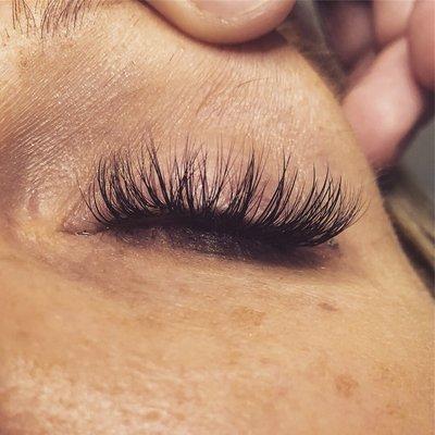 Volume lash extensions: multiple thin lashes applied per natural lash