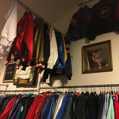 Some of our favorite Starter Jackets hanging high on display