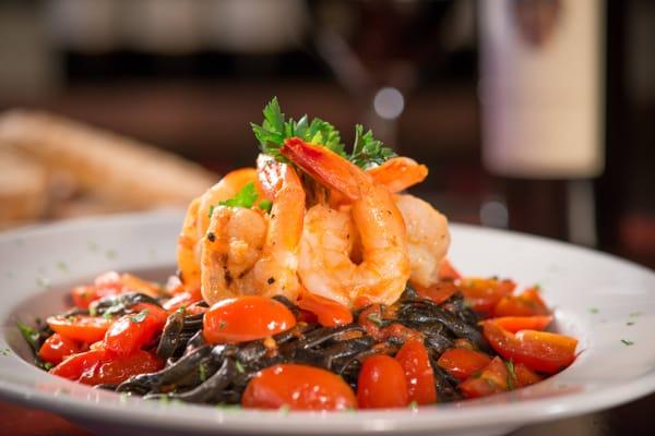 Gulf Shrimp, sauteed with garlic, oil, cherry tomatoes over hand made squid ink linguini