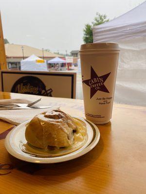 Cinnamon rolls and oat milk latte with cinnamon powder.