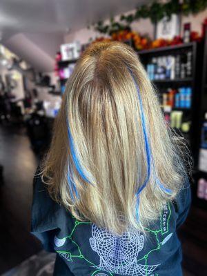 Using synthetic hair extensions to give a blonde just a little pop of color!