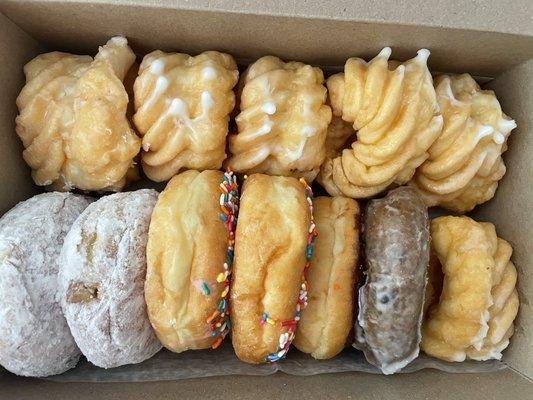 French cruellers, lemon, frosted strawberry sprinkle, and blueberry donuts