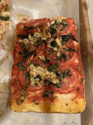 Focaccia slice with roasted tomato and onions