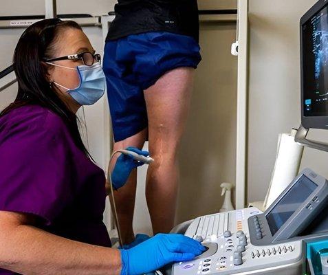 USA Vein Clinic Doctor looking at patient  legs