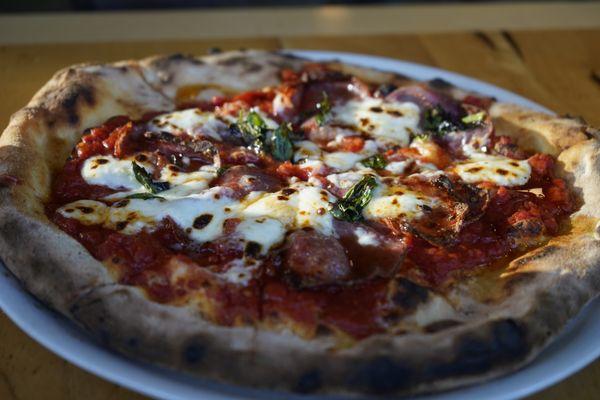 SOPPRESSATA pizza with tomato, mozzarella, and spicy honey.