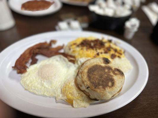 Dirty Grits (with bacon Cheese ) English Muffin  , eggs over medium , bacon