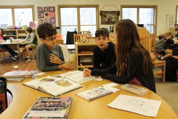 Upper Elementary students working on group research.