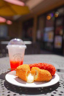 Original corndog with half-and-half filling, Fuego Takis with mozzarella cheese filling, and Strawberry Pearl lemonade.