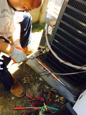 Installing a new AC condenser. Silver soldering.