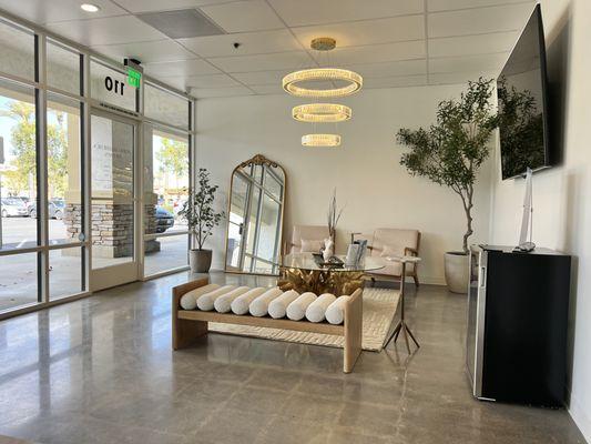 Waiting Area with mini fridge with Soft Drinks and Water while you wait.