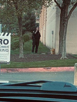 Home Depot's security smoking next to their open door