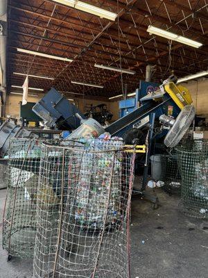 They dump the trash bins into these wire bins to weigh