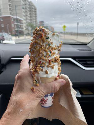 Kiddie size vanilla soft serve with peanut crunch coat