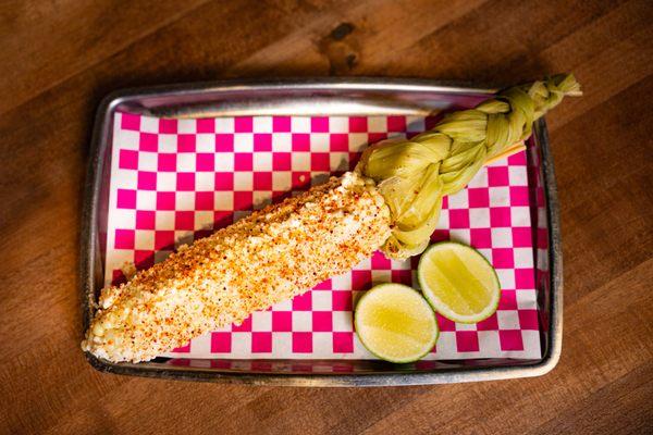 Mexican Corn - 
Creamy mayo sauce topped with chili powder, cheese, and lime.