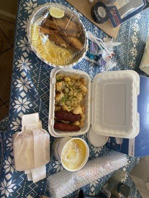 Fried tilapia, soft scrambled eggs, white toast, grits and two sides: home fries and hot beef sausage.