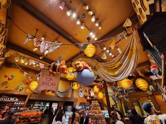 Cute Winnie the Pooh scenes hanging from the ceiling.