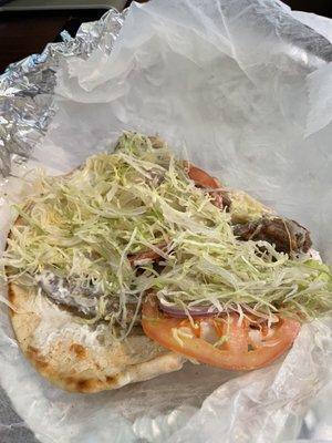 Lamb gyro, finely shredded lettuce, tomato, onion, and tsatziki.  Yum!