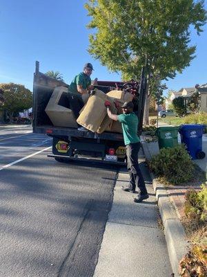 Team loading a truck from a furniture removal project.