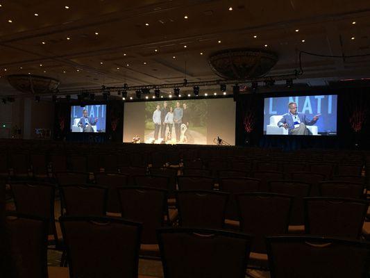 Corporate event with 20'x60' blended image screen and two 23'x13' flanking screens