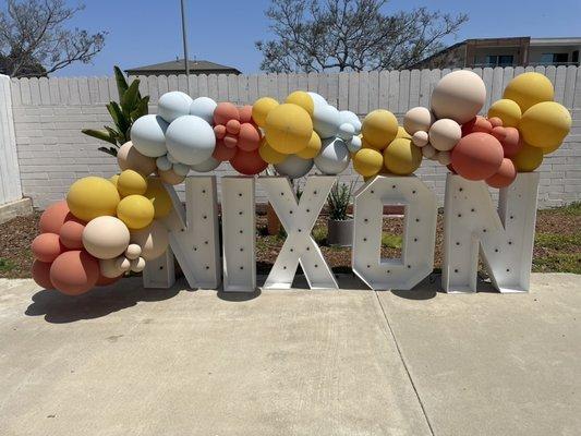 Marquee letters in the back patio paired perfectly with a balloon garland