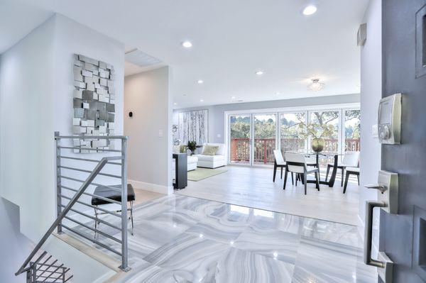 entry flooring leading into custom home wood flooring installation