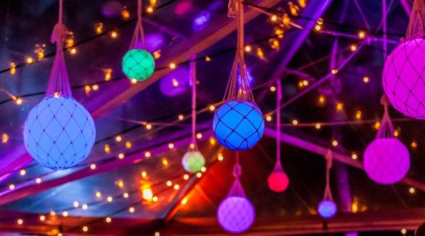 Net covered glow orbs lighting up the night sky at your wedding reception!