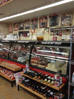 Deli counter with cold cuts, prepared food $ pizza.