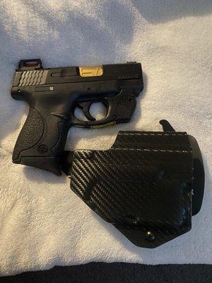 S&W M&P 9mm with laser sight and triclops sight on second slide.