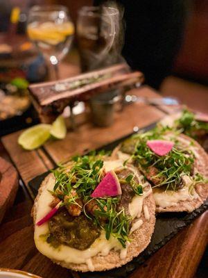 Tacos de Lengua (Beef Tongue) served with bone marrow, and a side of roasted jalapeños and onions