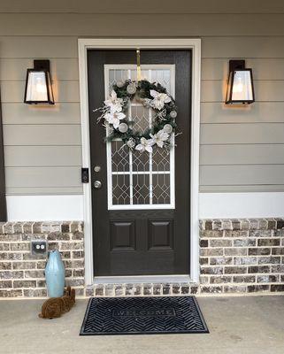 Installation of new exterior wall sconces at the front door.