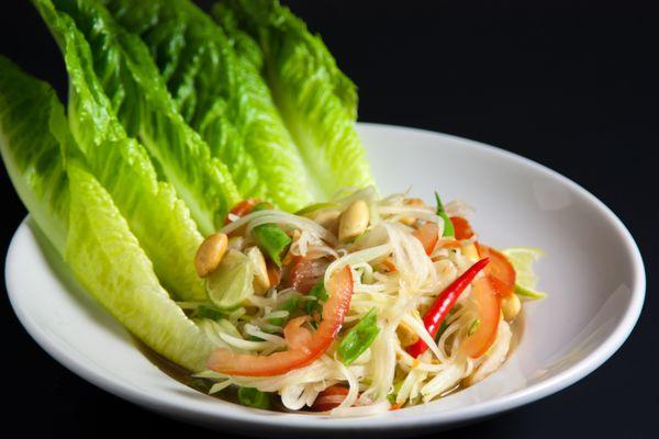 Papaya Salad - Fresh shredded green papaya with, carrots, tomatoes, green beans, peanuts, tamarind lime sauce.  Spicy level from 0-10.  GF!