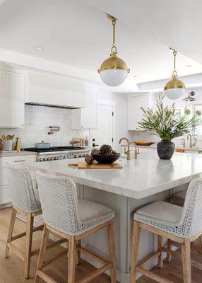 Quartzite countertops and brass accents give this kitchen timeless character