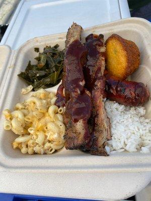 Large pork ribs with hot link, and sides of Mac & cheese, collard greens and white rice.