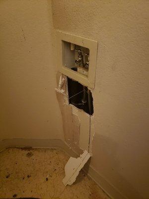 The plumber tore a hole in the wall to reach the pipes, super sloppy...