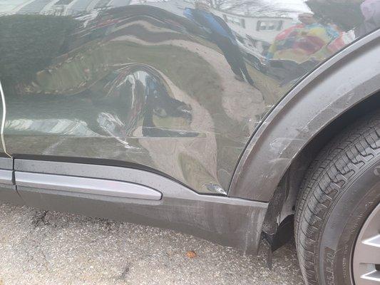 The damage to my rear driver's side door, as well as the front wheel well accent piece