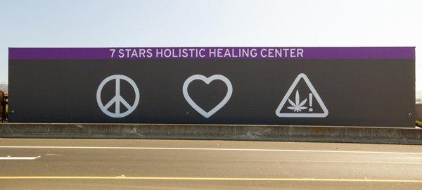 The peace, love, cannabis mural on the 7 Stars dispensary building you can see from I-80.