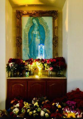 December 12th was the Feast Day of Our Lady of Guadalupe, which accounts for the multitude of flower offerings.