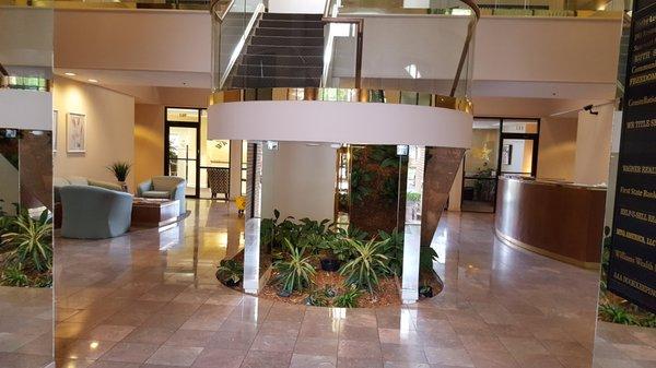 The view leading to the stairwell and elevator entry in the main buildings corridor.