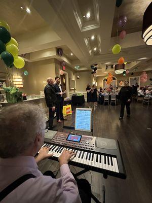 I am playing the piano at a party in their private room.