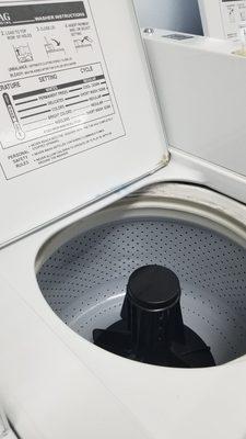 Clean washer basket but dirty lid and surrounding area.