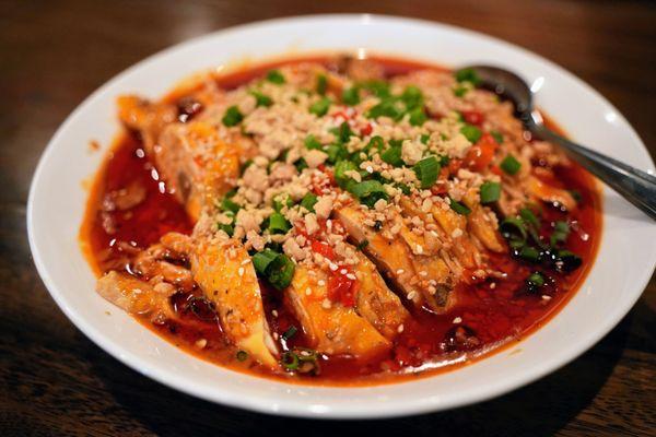 Mouthwatering Chicken (重庆口水鸡): chicken leg quarters, topped with roasted peanuts, scallions, sesame seeds, sesame-peanut sauce ($16.99).