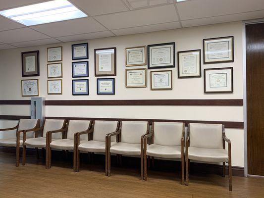 Waiting area with physician's training certificates and medical school diplomas