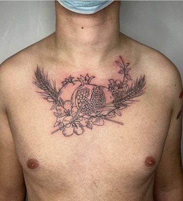 Fine line pomegranate chest piece by Jordi