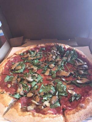 Large mushroom and spinach no cheese pizza.