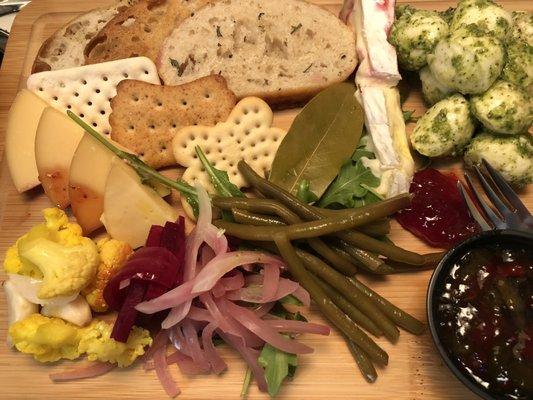 The cheese plate boarded up for consumption.